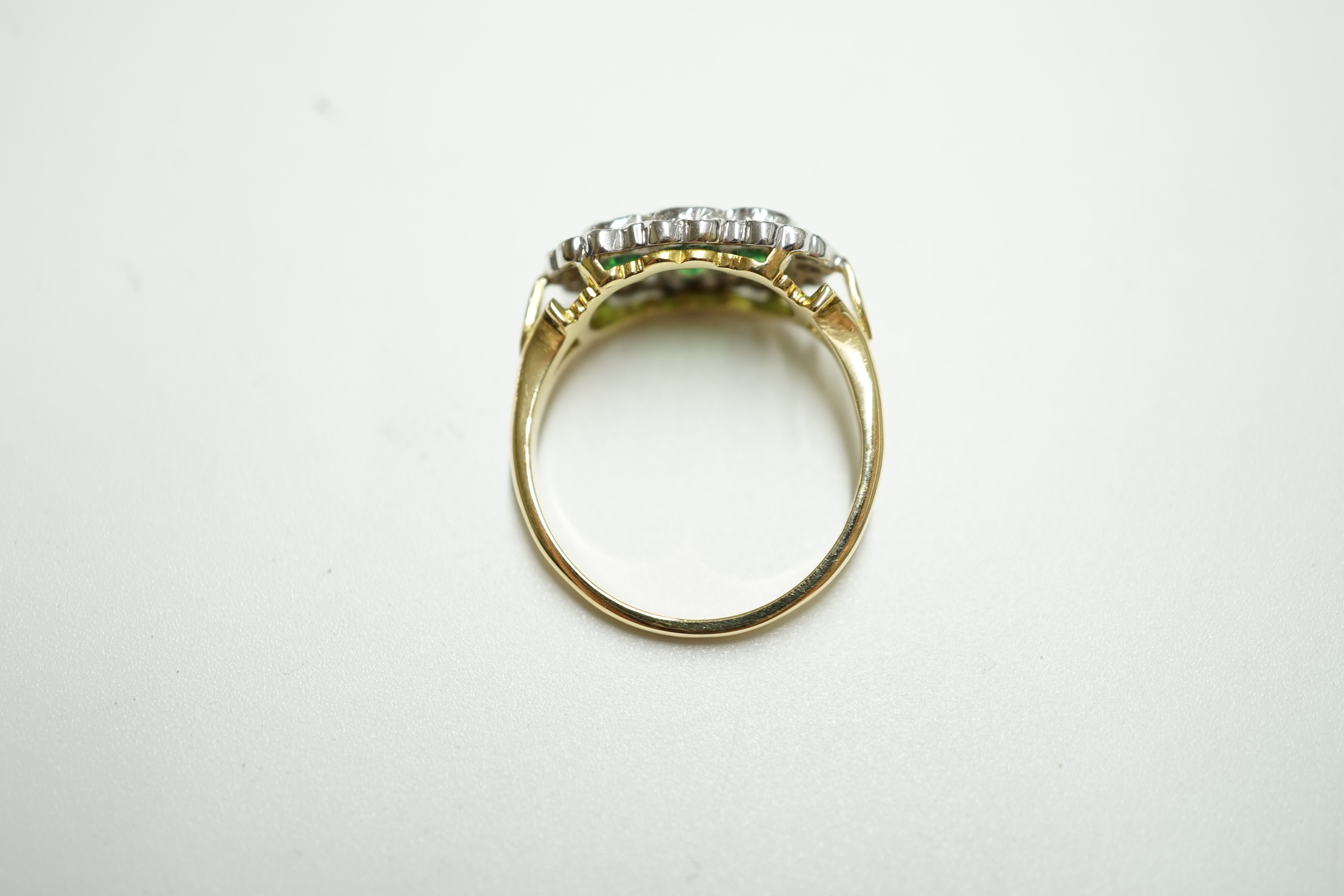 An 18ct, three stone tsavorite garnet and diamond set triple cluster ring, size Q, gross weight 5.2 grams. Condition - Good